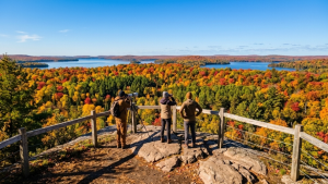 Hikers overlooking fall colours in Algonquin Provincial Park Ontario